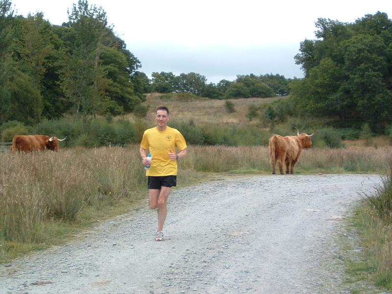 DSCF0090 The local spectators were out in force for the long Sunday run through Achray Forest. Eddie Reid strides out on the 17 miler.